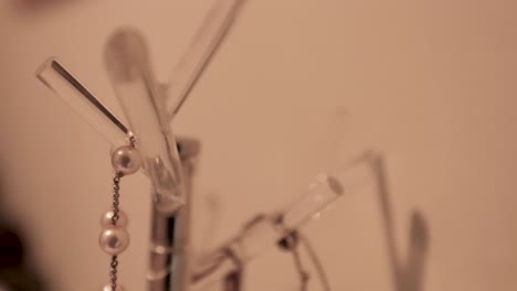 necklaces on display on hanging tree branch holder