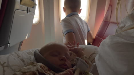 baby girl traveling by plane with family is waking up