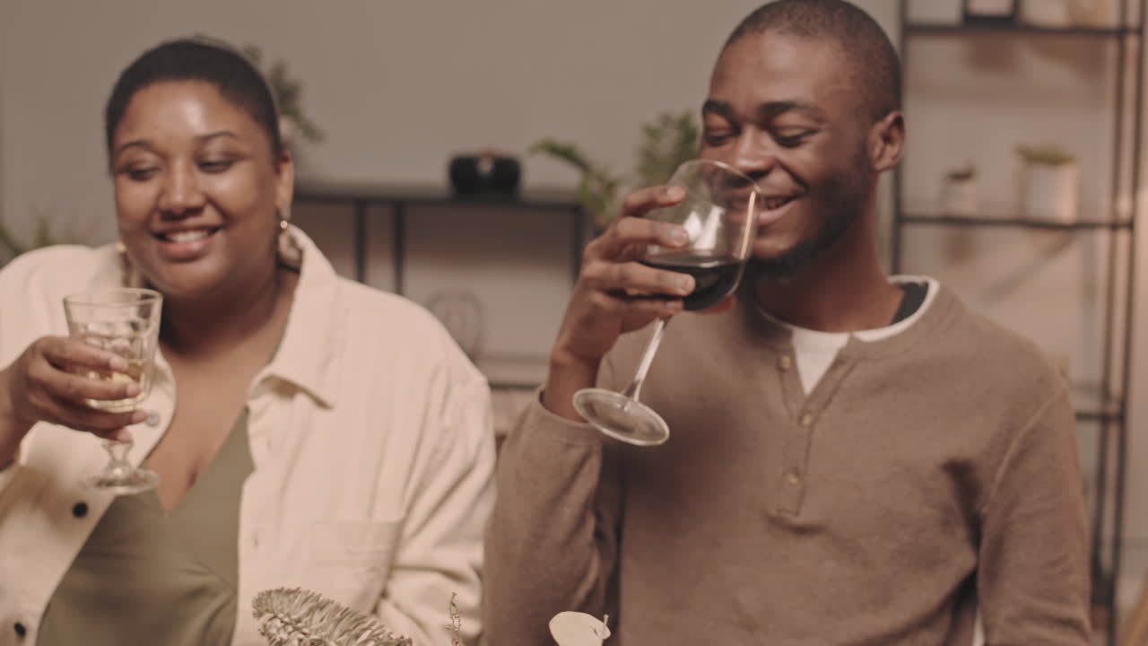 Couple toasting with wine glasses at dinner