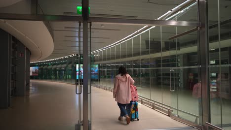 dublin aairport gate sign in irish and english, woman with luggage going to gate