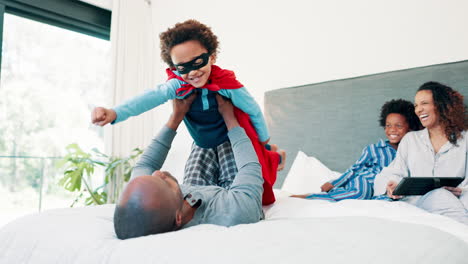 father playing superhero with his children
