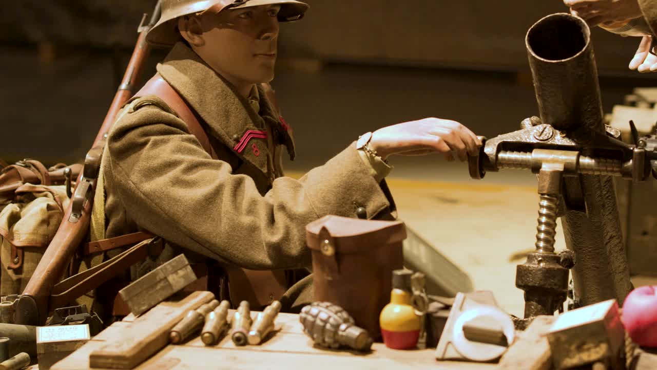 Mannequin soldier with vintage machine gun, surrounded by ammunition, crates, and sandbags under warm lighting