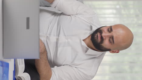 Vertical-video-of-Home-office-worker-man-loosening-his-tie-from-stress.