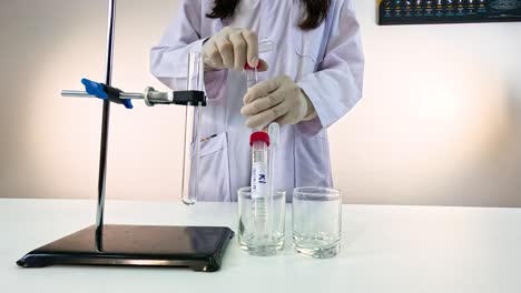 Scientist conducts a bromothymol blue experiment in a lab setting with controlled lighting and precise equipment