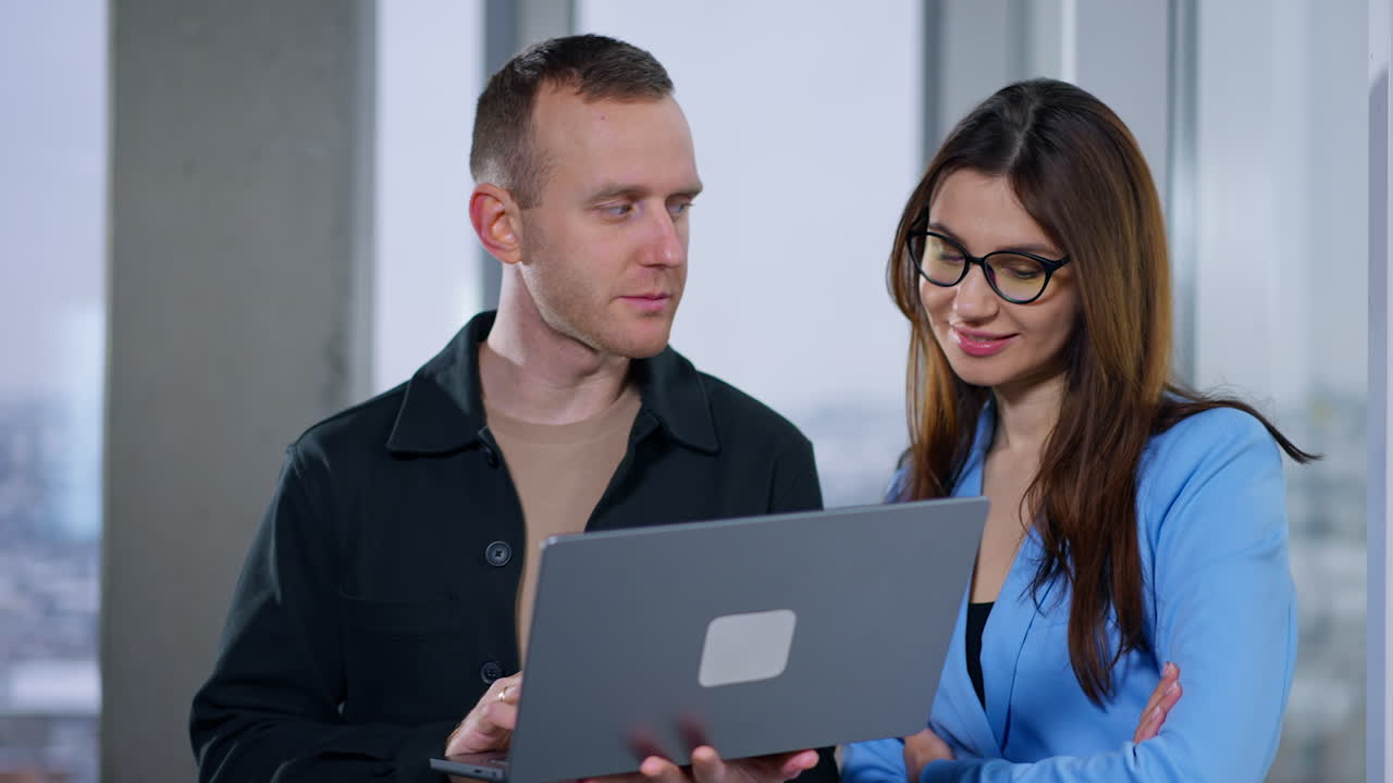 Business Colleagues Collaborating on Laptop