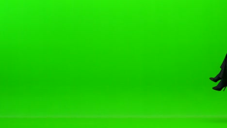 the happy woman playing on the office chair on the green background