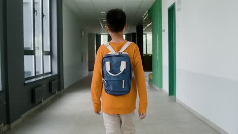 Schoolboy-walking-through-the-corridor.