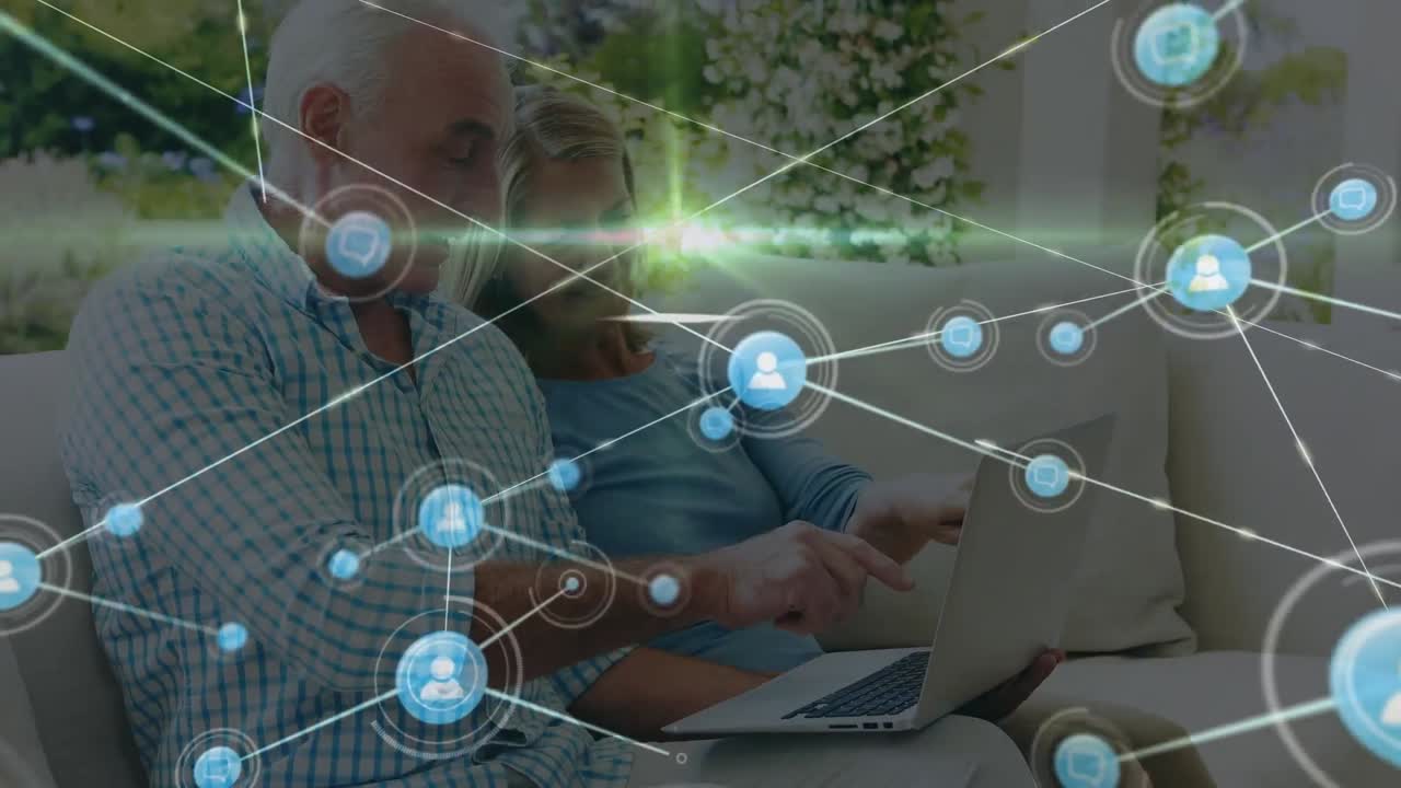 animación de la red de conexiones con iconos sobre pareja caucásica usando portátil