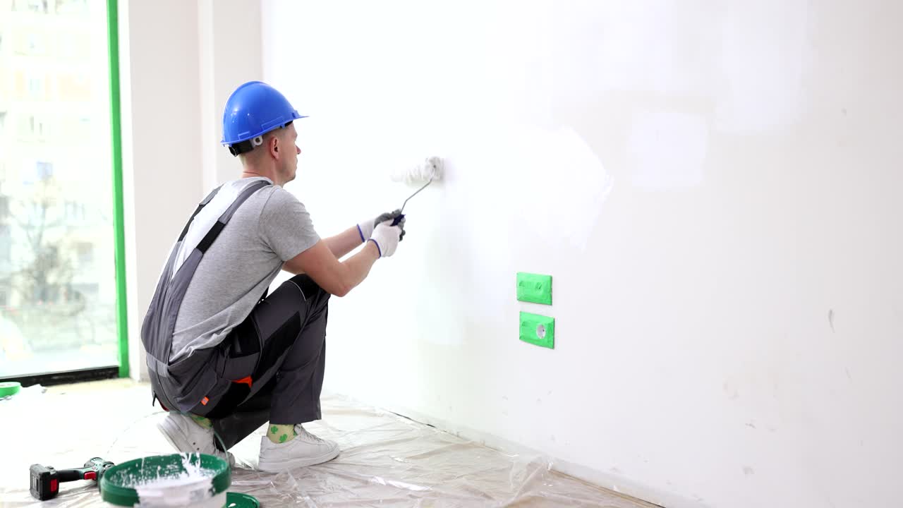 Man Painting a Wall During Home Renovation