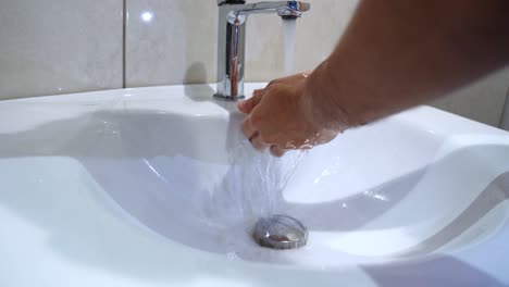 close-up of hands being washed with soap at a bathroom sink. perfect for hygiene, healthcare, or sanitation content.
