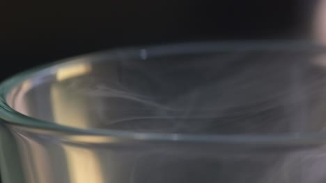 macro view of a smoke rising from a glass