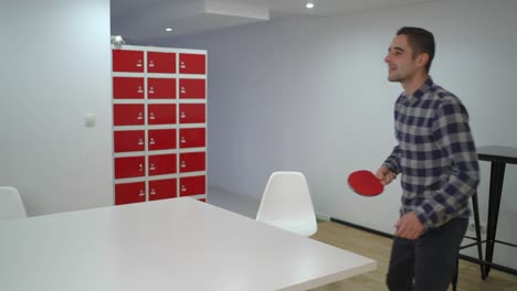 diverse colleagues playing ping pong at work