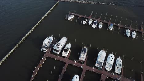 Birds-Eye-Aerial-View-of-Upscale-Marina-and-Harbor-by-Jetty-in-Chesapeake-Bay,-Maryland-USA