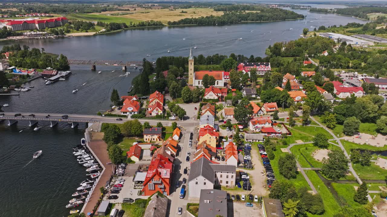 Beautiful aerial footage of Mikolajki with Holy Trinity Church and lake scenery