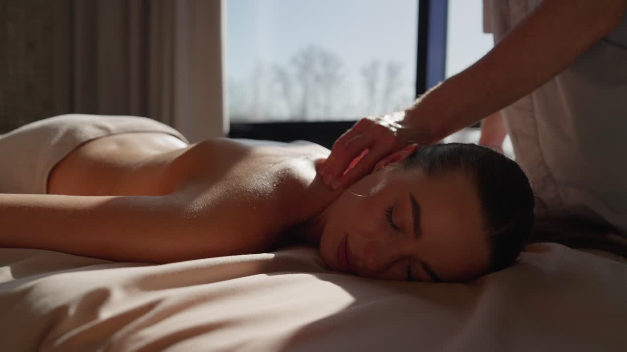 Woman Receiving Relaxing Neck and Back Massage at a Spa
