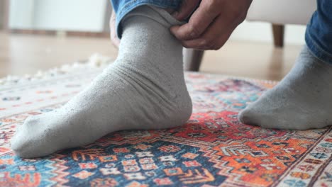 man putting on socks