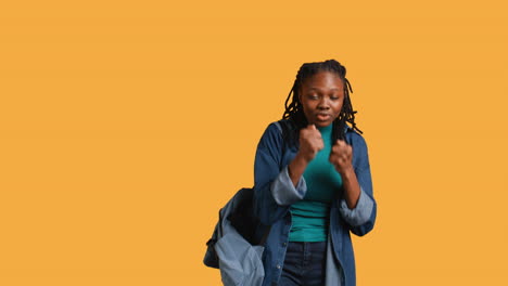 Woman-jokingly-pretending-to-fight-with-friend,-studio-background