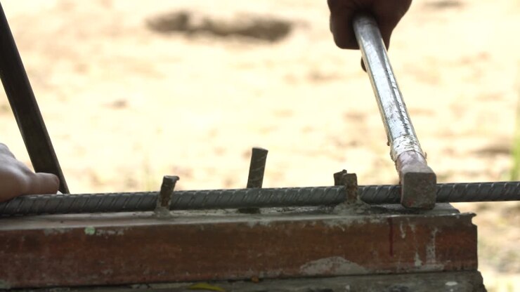 Worker bend steel line in to square shape. To construction building.