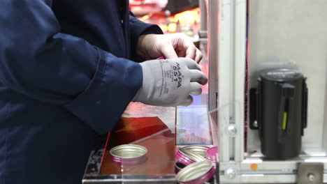 worker inspecting quality control, cap lining machine processing