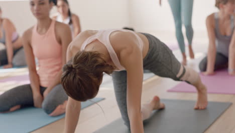 yoga class beautiful young woman stretching flexible body practicing poses on exercise mat enjoying warm up preparing for workout in fitness studio