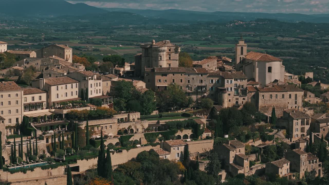Left tracking of Gordes, Provence, France, showing charming village streets and historic architecture, establishing overview