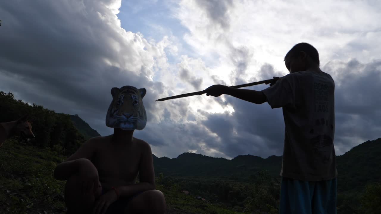 Boy Hunting Another Boy Wearing Animal Mask