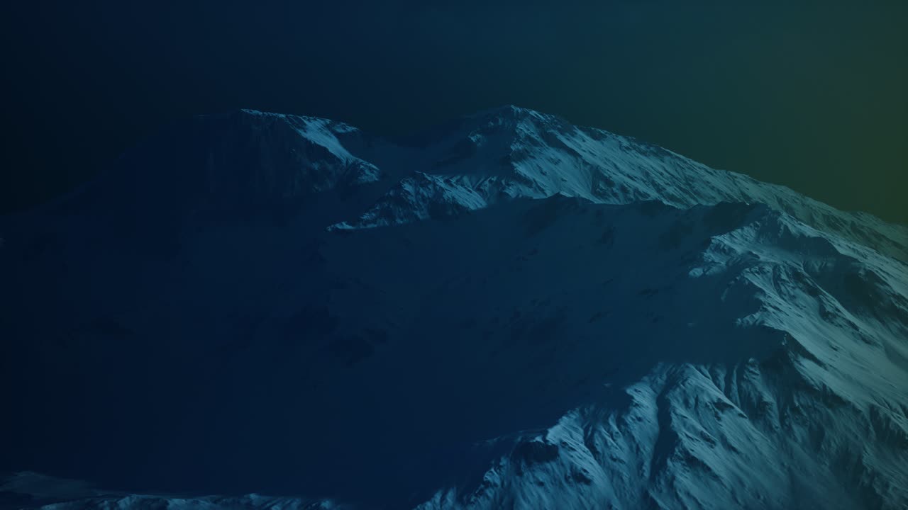 Dramatic dark rocky mountain with patches of snow in storm