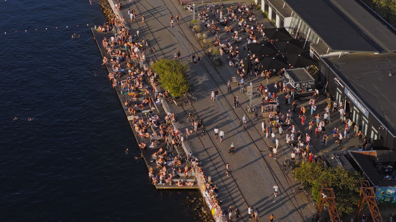 Aerial drone view of Copenhagen Street Food and La Banchina area with people relaxing by the water