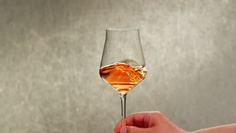 rose orange or white wine bottle and glass against a sunset in a peaceful vineyard, pouring of ecological natural wine. cheers, hands with wine glasses, drinking alcohol.