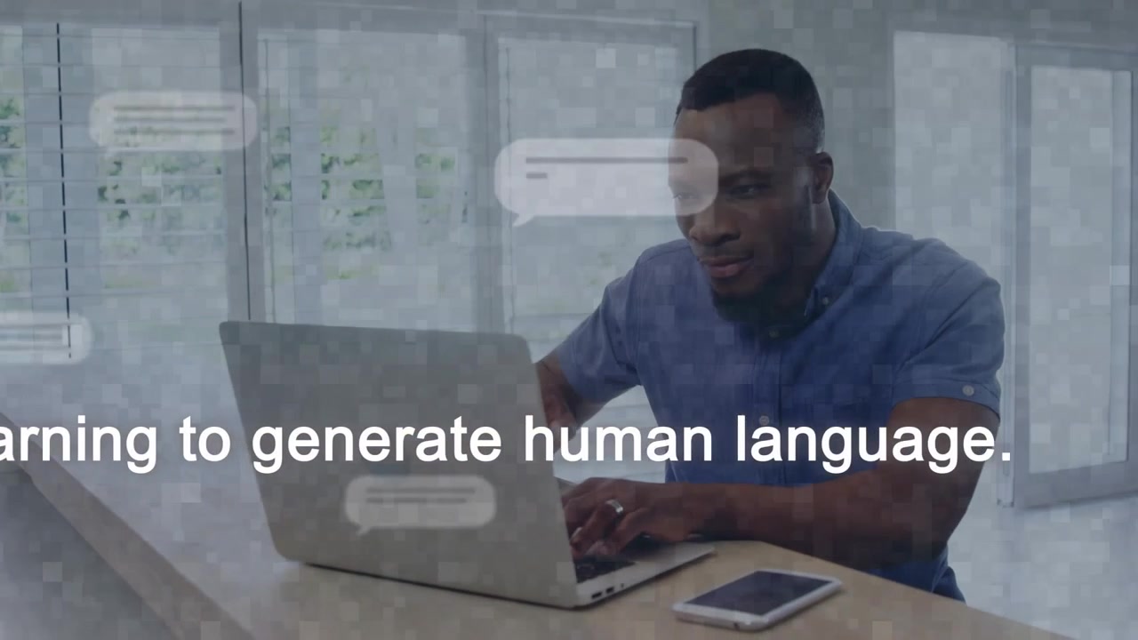 Man typing on laptop activating chat bubbles and robot icon while reading chatbot text with phone