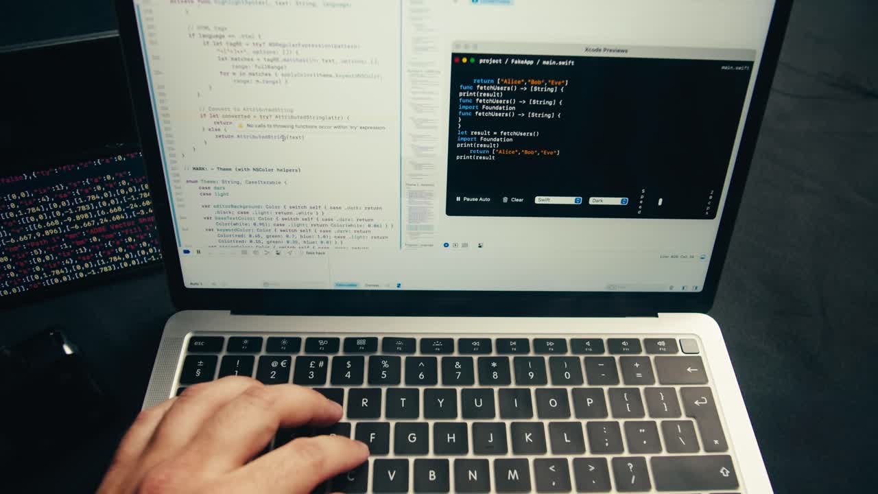 Programmer Typing Code on Laptop Keyboard