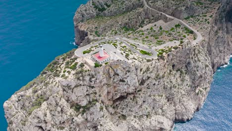 Aerial-descend-and-tilt-up-motion-near-Formentor-Lighthouse,-Mallorca