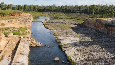 drone footage of river flowing through eroded land