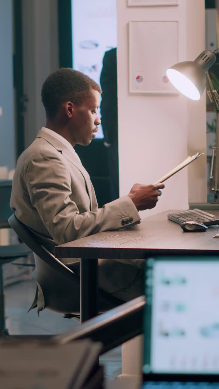 Vertical video Coworkers finishing tedious paperwork
