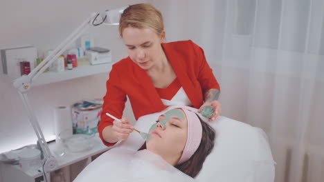 woman receiving a facial mask treatment