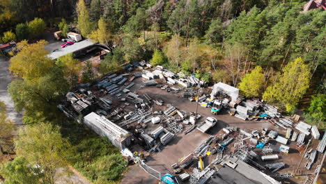 aerial view of a junkyard at the countryside with heap of discarded steel and metal