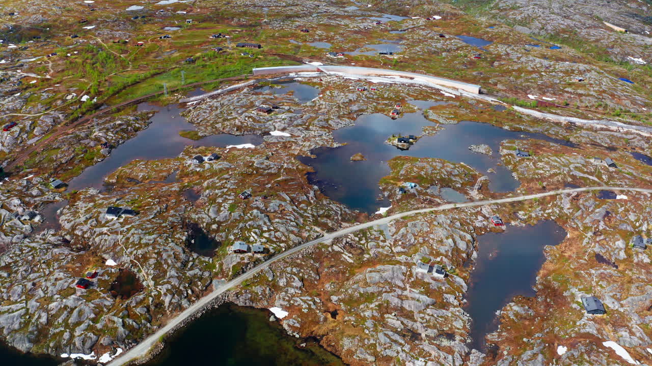 Aerial drone shot of the nordic rocky landscape of the town of Bjørnfjell at the Swedish border.
High view of the arctic tundra and vast wilderness.