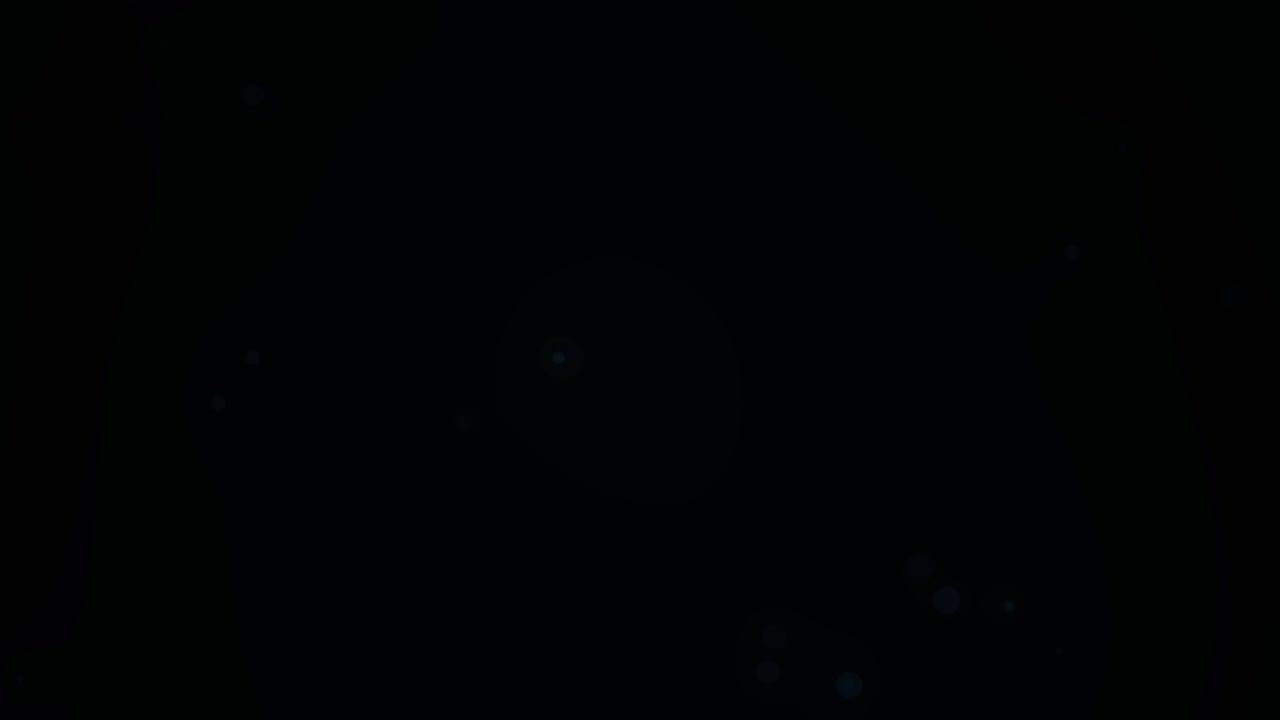 Abstract Floating Blue Particles on Dark Background