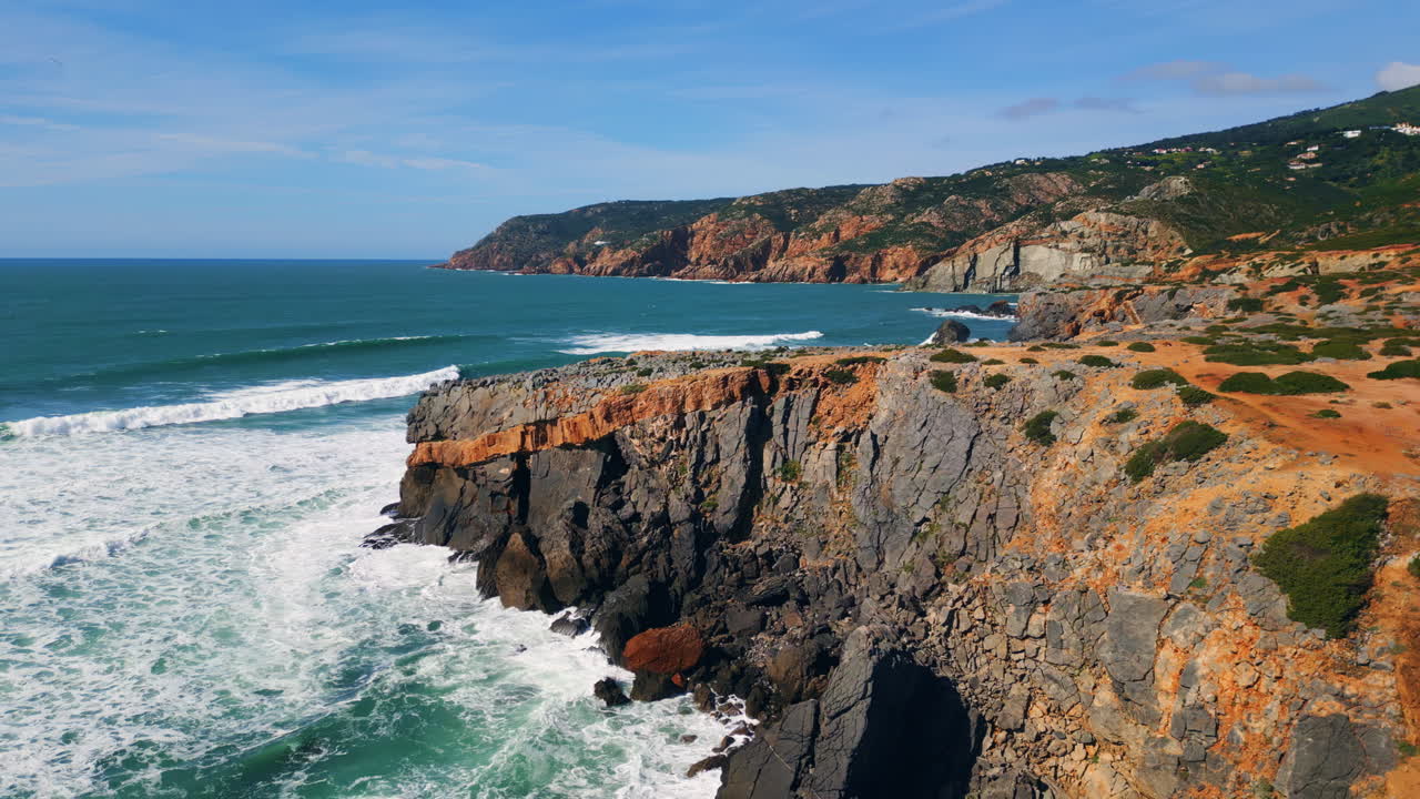 Foamy sea breaking dangerous cliffs seashore in slow motion. Drone ocean waves