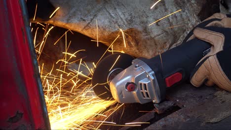 Angle-Grinder-on-Rusty-Truck-Metal-Cutting-Sparks-from-Side