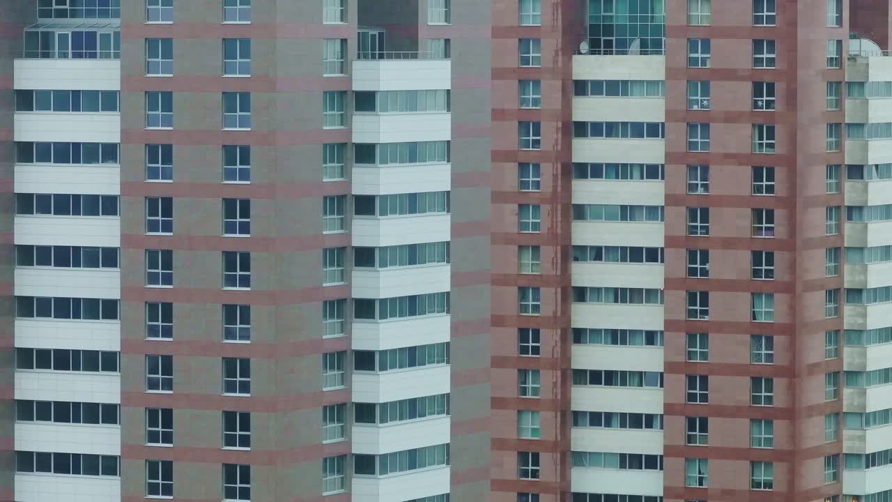 Close-up view of modern high-rise residential buildings, repeating glass facades