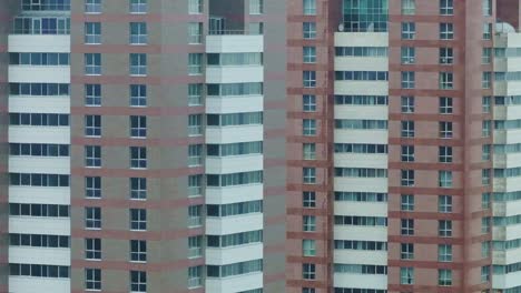 close-up view of modern high-rise residential buildings, repeating glass facades