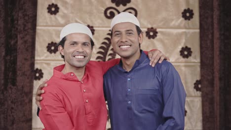 two happy muslim friends hugging and enjoying