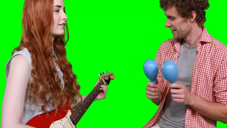 Musician-playing-maracas-and-electric-guitar