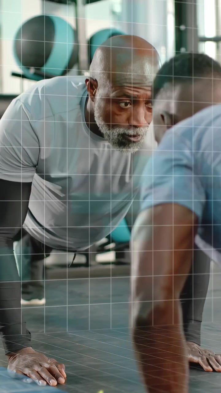 Vertical video: Mature man plank start guiding form, doing matching pushups in gym with data grid