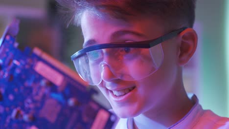 close-up face of boy admiring electronic clipboard.