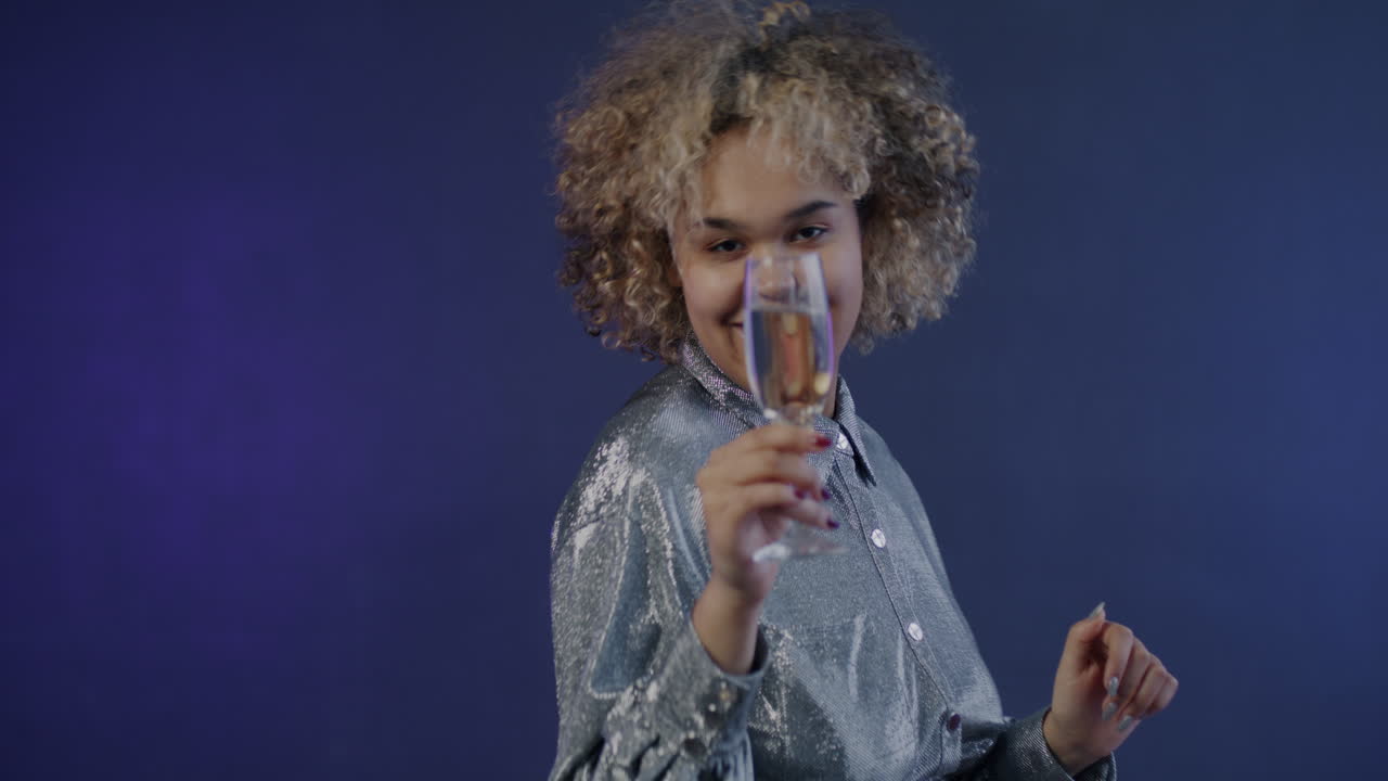 Happy woman dancing with champagne