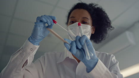 woman doctor taking sample for corona test close up. physician holding tube.