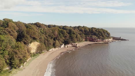 Vista-Aérea-A-Lo-Largo-De-La-Playa-De-Arena-En-Ravenscraig-Fife-Con-Escaleras-Al-Parque-Y-Torres-En-La-Distancia