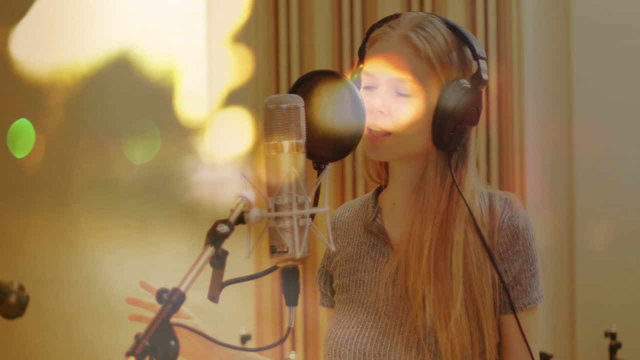 Female vocalist singing in music studio, with headphones and sound waves pulsing around microphone